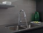Brushed nickel kitchen faucet with drop-down spray nozzle